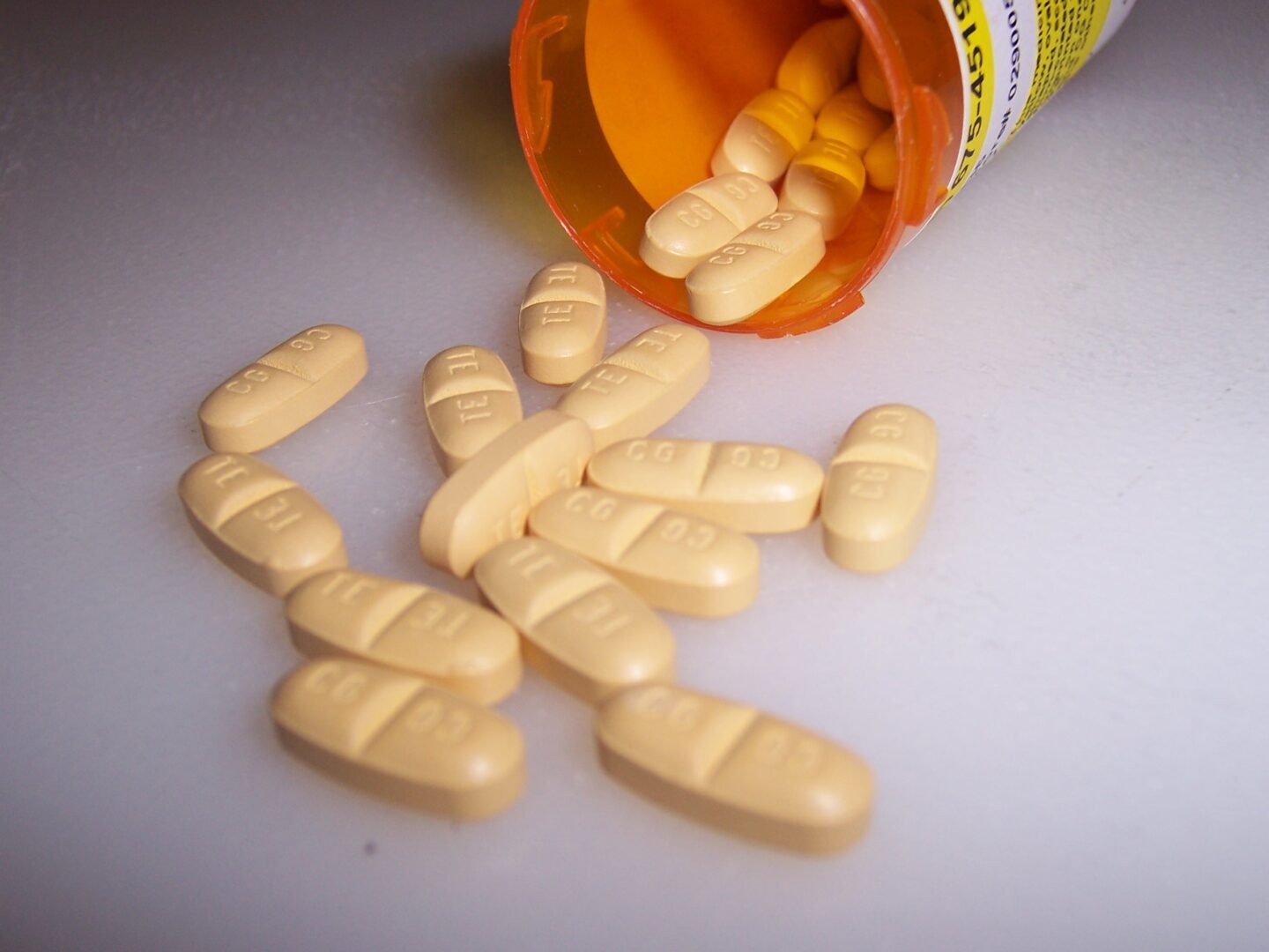 A close up of pills and a bottle