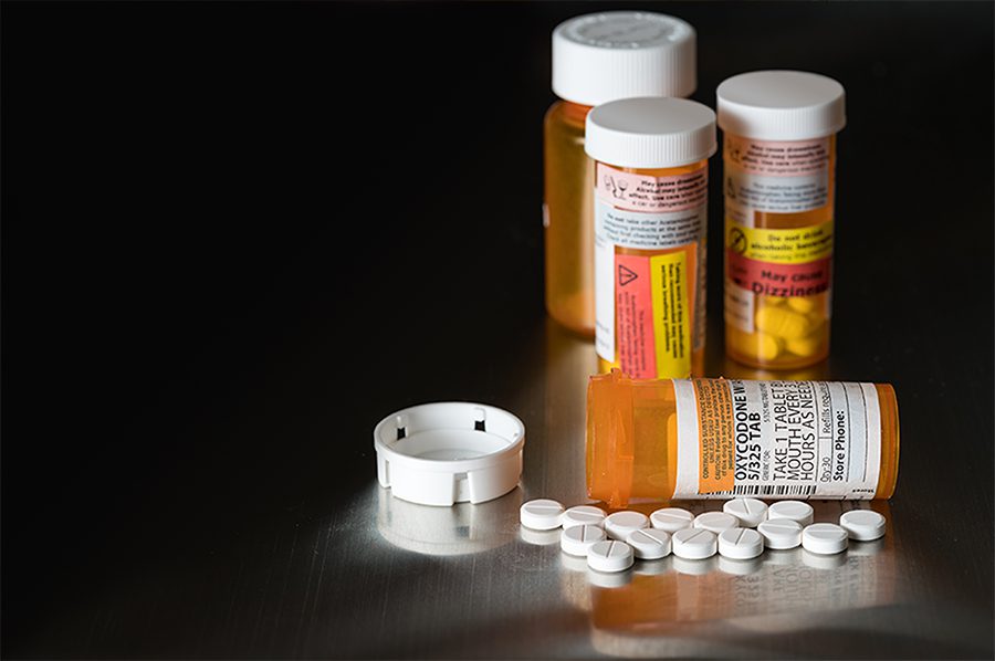 A table with several different types of pills and bottles.