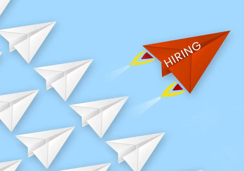 Paper airplane with hiring wrote on it ahead of the rest