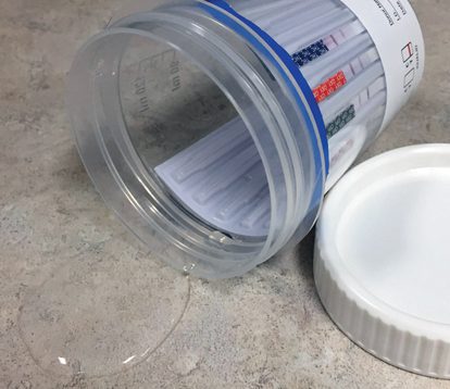 Spill-proof urine drug test cup design
